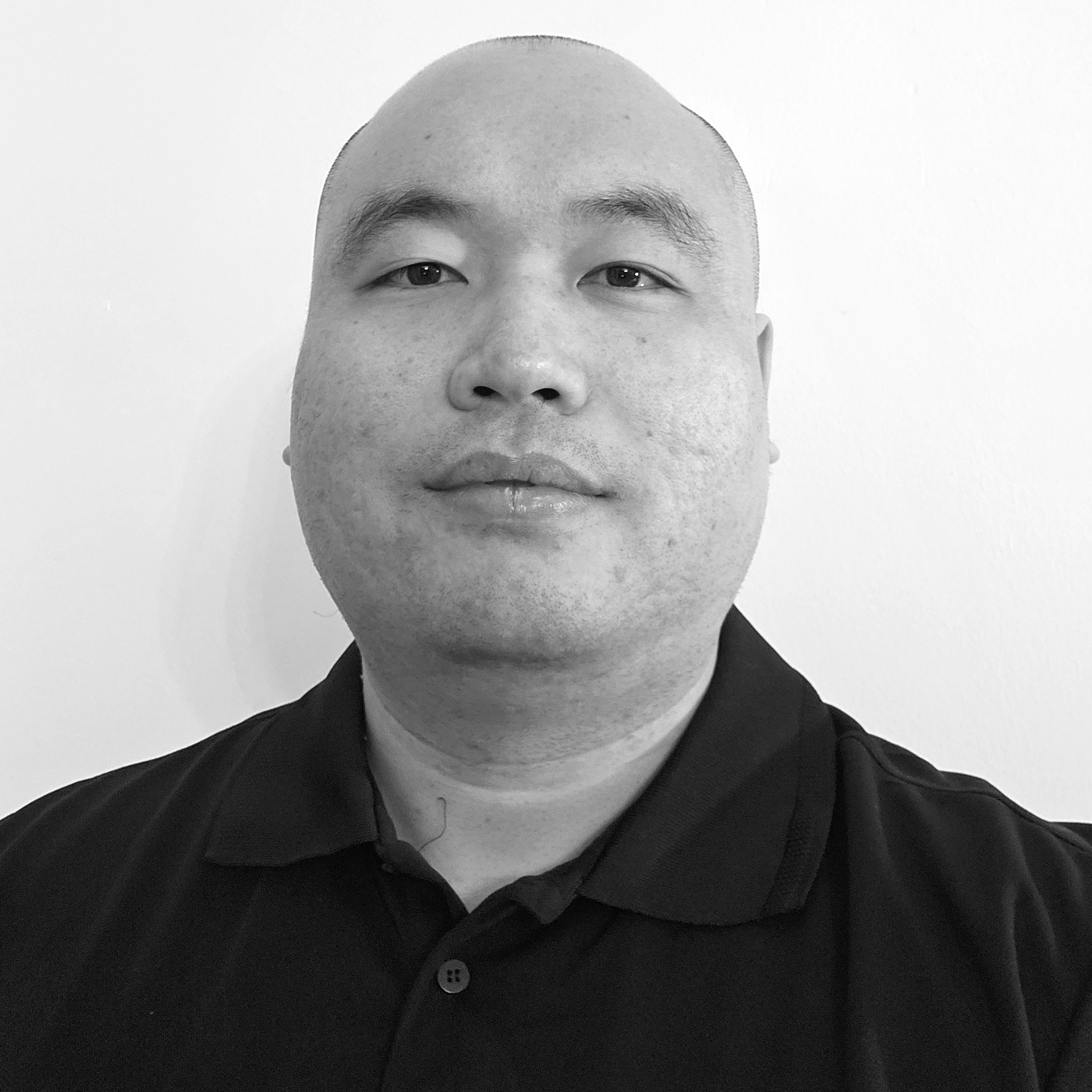 A professional portrait of Andrew Wang, Head of Tech